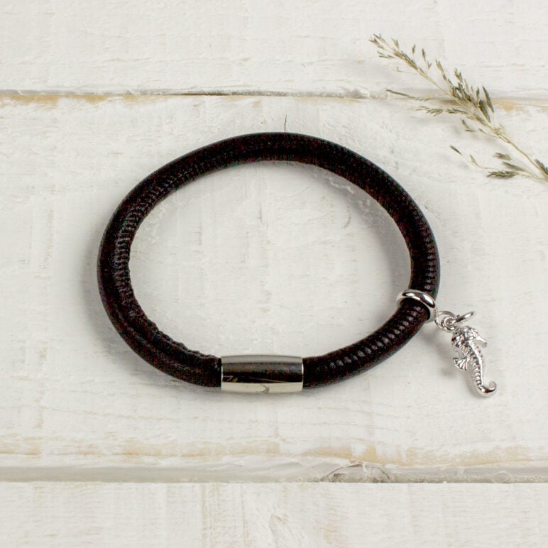 Silver Seahorse Charm pictured on a black leather bracelet