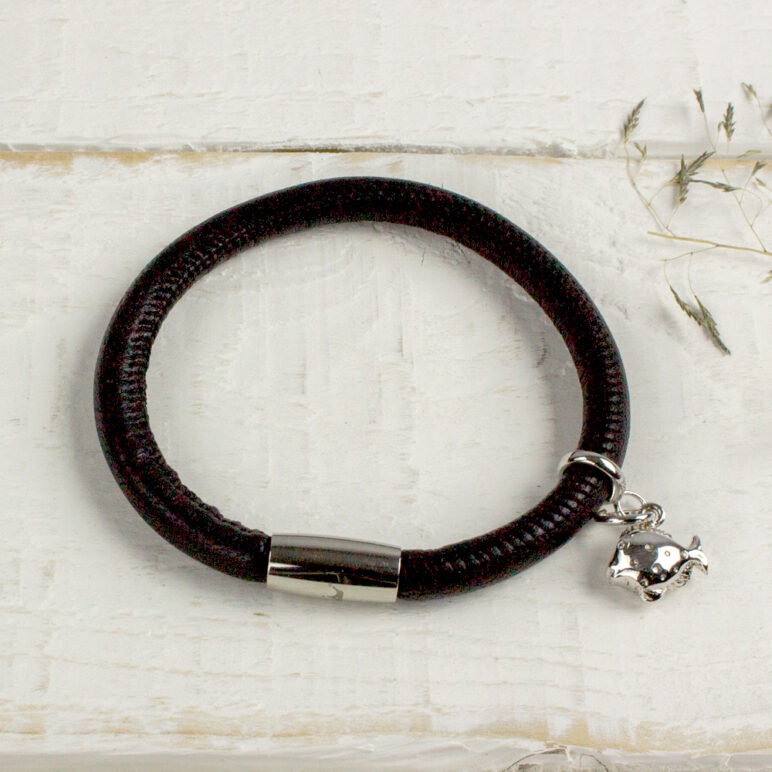 Silver Fish Charm pictured on a black leather bracelet