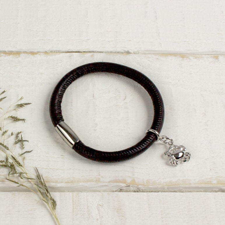 Silver Crab Charm pictured on a black leather bracelet