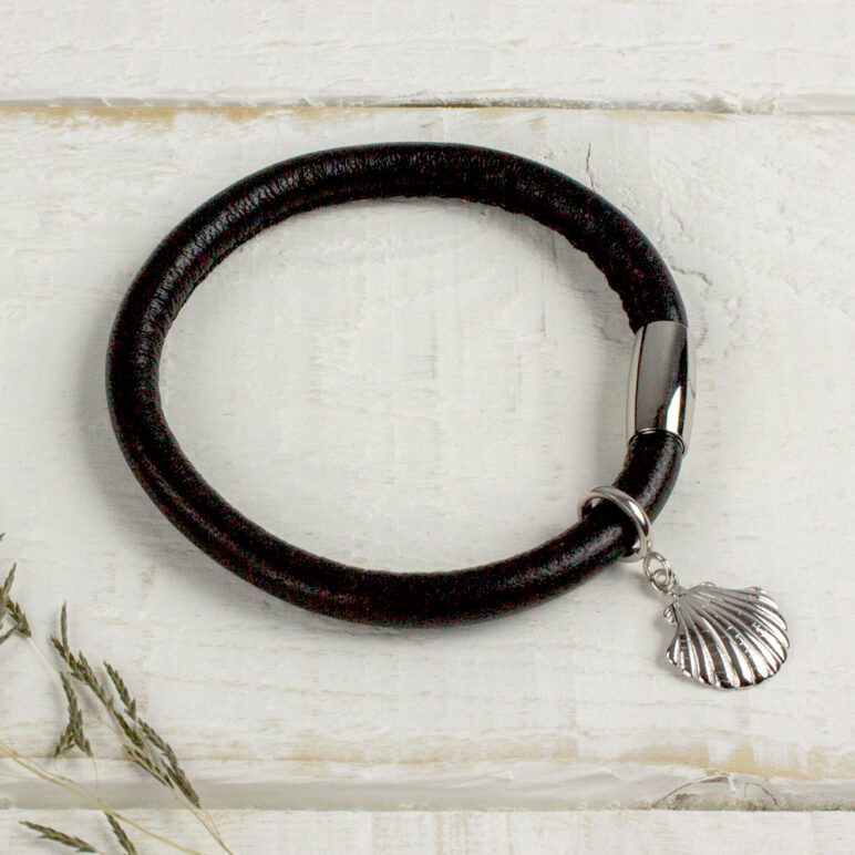 Silver Shell Charm pictured on a black leather bracelet