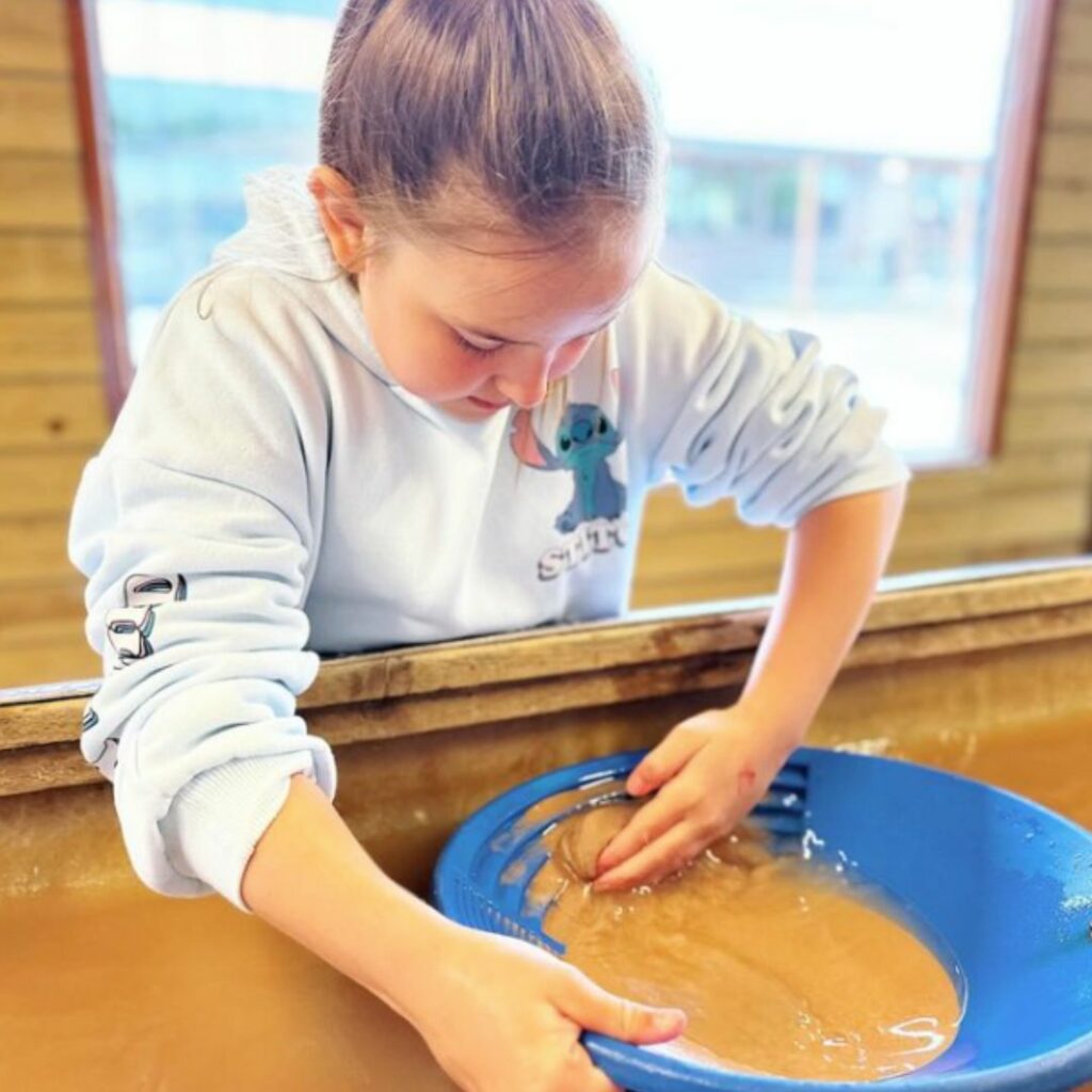 photo of young girl panning for gold at cornwall gold